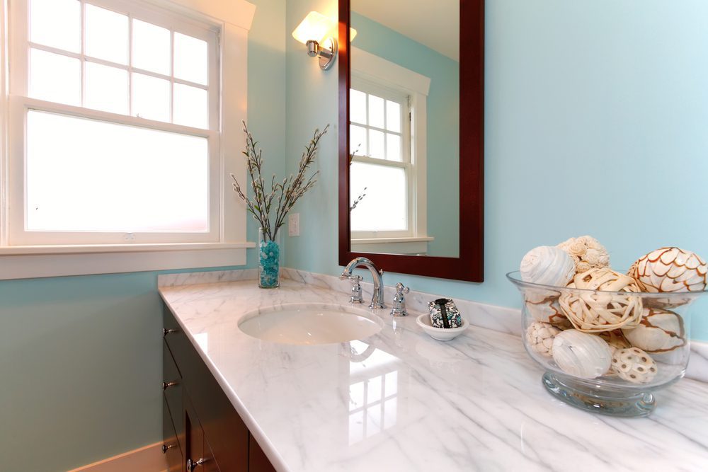 blue bathroom with white marble sink.